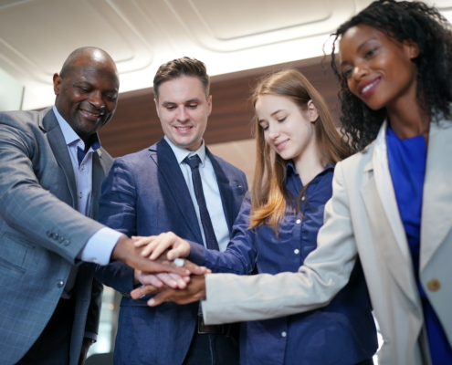 A diverse group coming together as a team during a business meeting